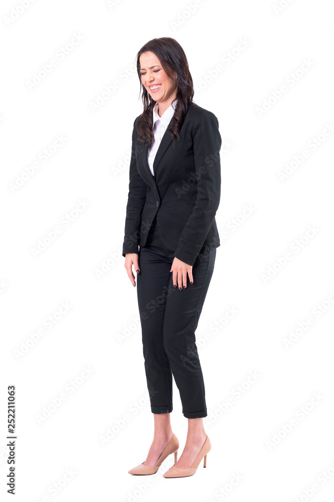 Spontaneous candid business woman in formal suit laughing with closed eyes. Full body isolated on white background. Spontaneous candid business woman in formal suit laughing with closed eyes. Full body isolated on white background.