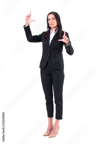 Elegant business woman interacting and resizing with fingers on virtual reality screen. Full body isolated on white background. 