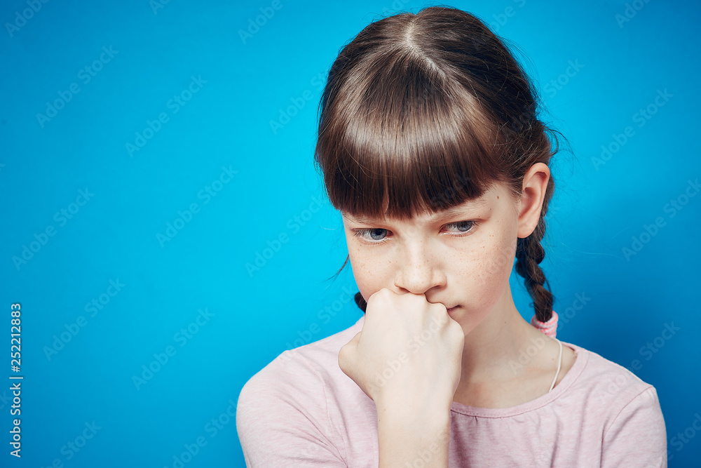 sad pensive thoughtful girl looking down. emotion and facial expression sad pensive thoughtful girl looking down. emotion and facial expression