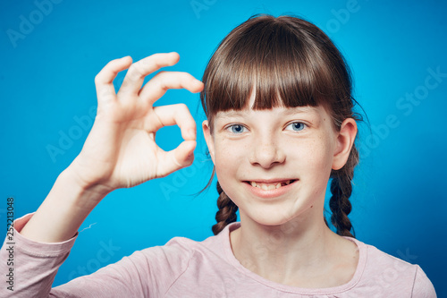 ok gesture. smiling adolescent girl. happy facial expression