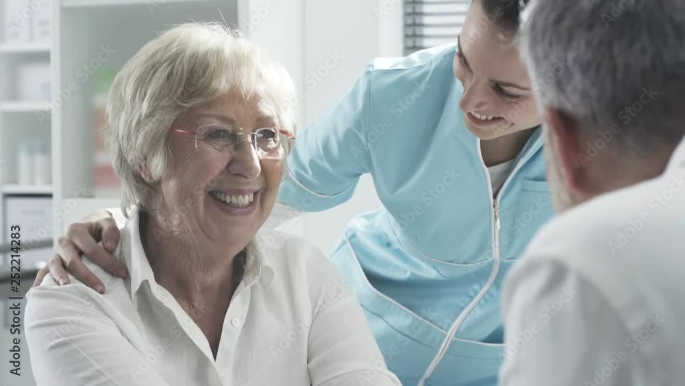 Medical staff supporting a senior patient Medical staff supporting a senior patient