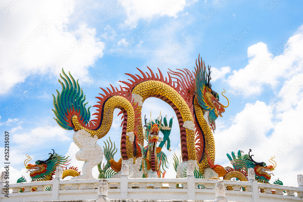 Fototapeta premium Beautiful giant or big colorful dragon statue with blue sky