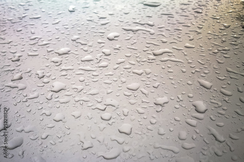 Water drops or rain on the roof of car.