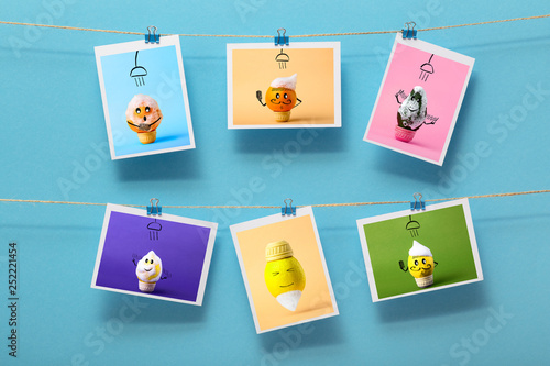 pictures with funny washing fruits hanging on a linen thread on stationery clips on a colored background, concept of cheerful mood, design of a children's wall decor, advertising of food business
