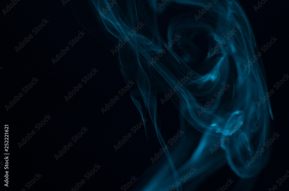 Blue smoke on black background