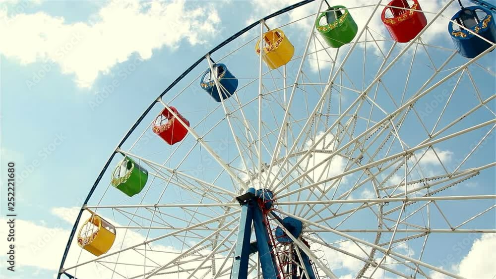 Underside view of a ferris wheel over blue sky Underside view of a ferris wheel over blue sky