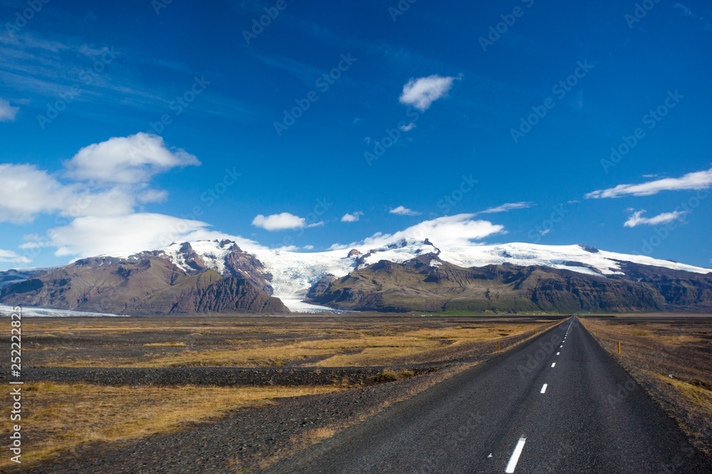 The road against the backdrop of mountains and glacier The road against the backdrop of mountains and glacier
