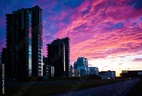 Silhouette of city buildings in the evening with bright clouds © think2006