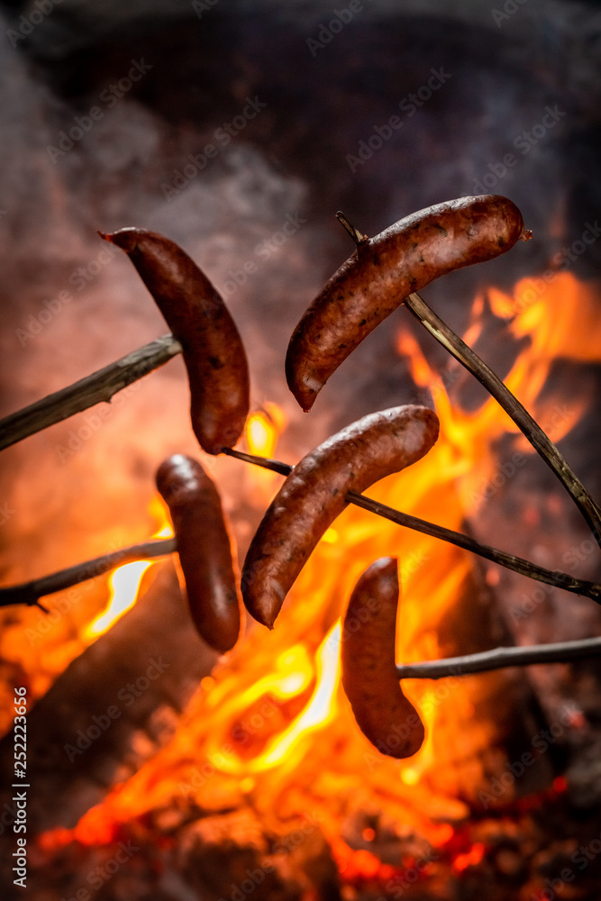 Fototapeta premium Hot and spicy sausage roasted on the bonfire