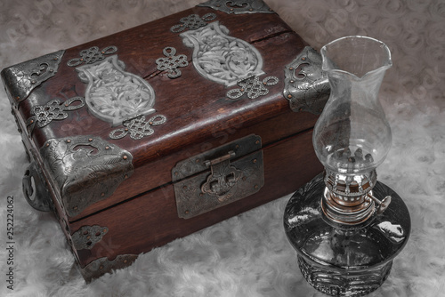 close - up of an old chest with a vintage lamp.  tint photo