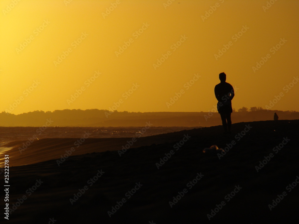 Man at the beach on sunset