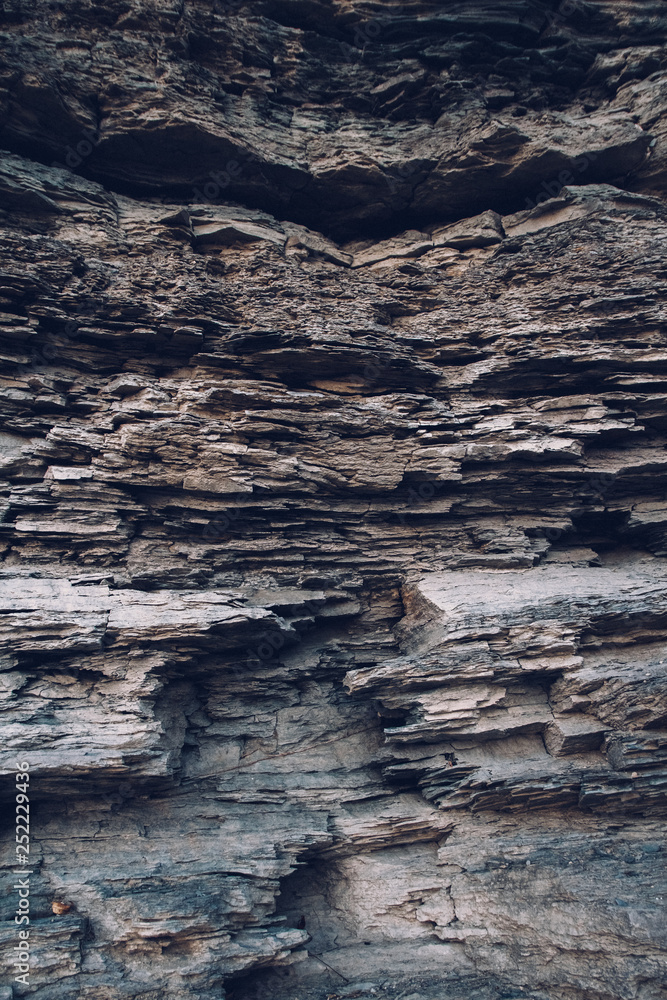 Fototapeta premium Surface of an stone wall. Black Stone background. Rock texture. Rock pile background