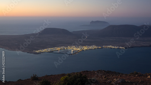 Panoramic view from the Mirador del Rio in Lanzarote during sunset with the island of La Graciosa