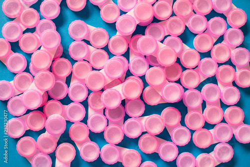 Pink contact lens cases on blue background