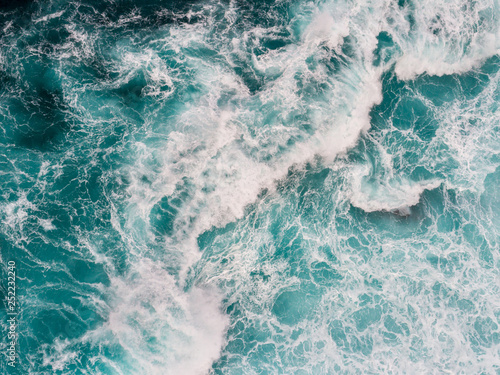 Aerial top down shot of ocean or sea surf during the storm