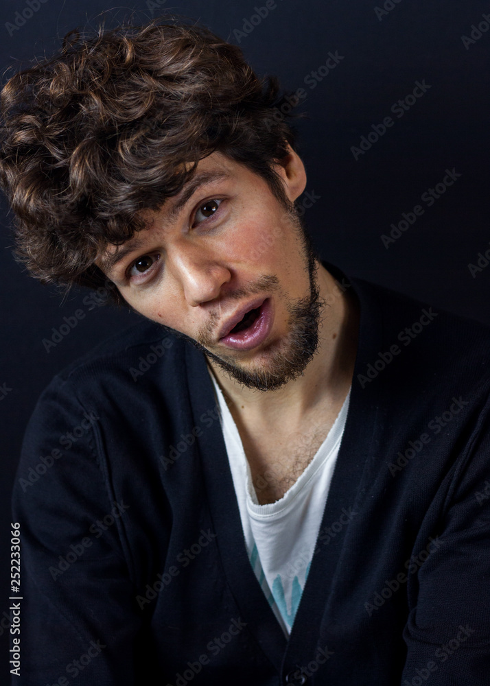 Obraz premium Curly man portrait on dark studio background