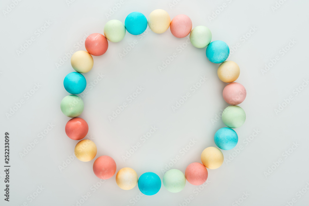 top view of colorful easter eggs as circle frame isolated on grey top view of colorful easter eggs as circle frame isolated on grey