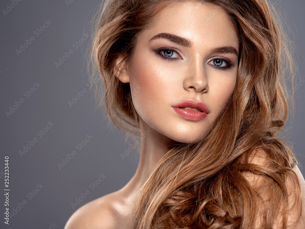 Young brown-haired woman with long curly hair. Young brown-haired woman with long curly hair.