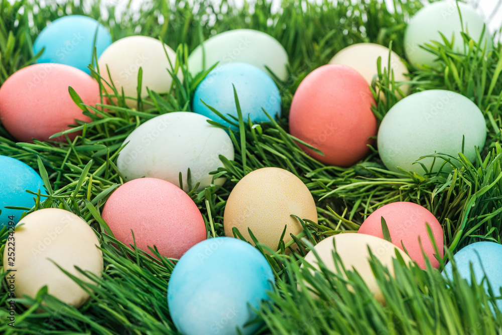 Close up of colorful easter eggs on green grass
