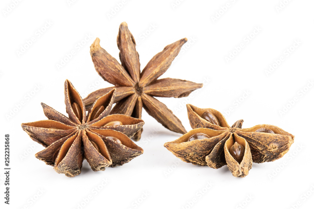 Group of three whole dry brown star anise fruit one is like a butterfly isolated on white background Group of three whole dry brown star anise fruit one is like a butterfly isolated on white background
