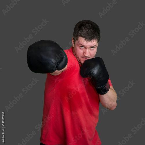 White male boxer in Boxing stand during training isolated on grey background