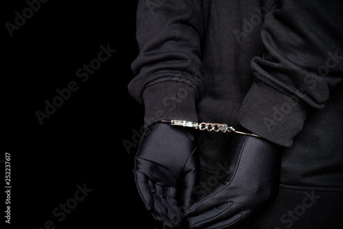 arrested man in handcuffs with hands on back