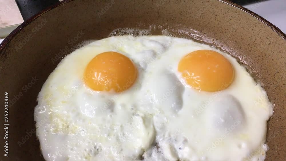 Cooking eggs in a frying pan. Top view. Cooking eggs in a frying pan. Top view.