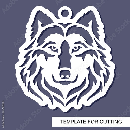 Wolf head silhouette. Hanging toy or pendant. White character on a grey background. Template for laser cutting, wood carving, paper cut or printing. Vector illustration. photo