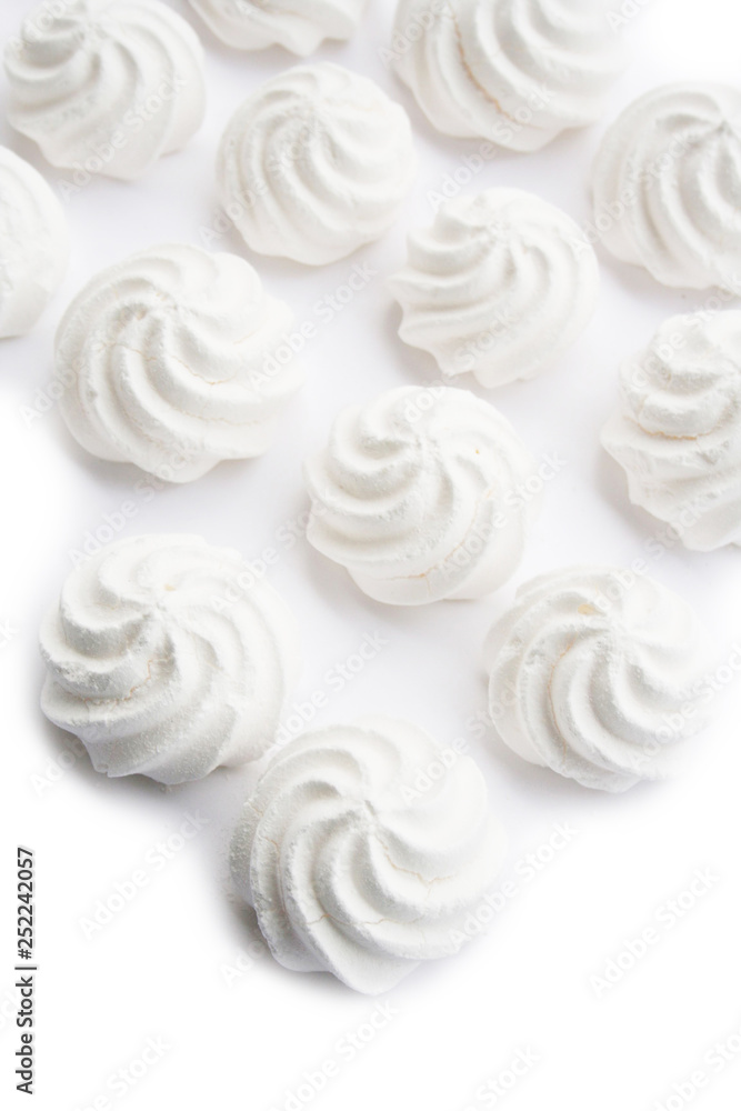 Small white meringues isolated on white background Small white meringues isolated on white background