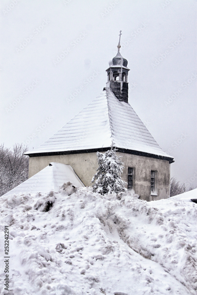Little chapel over the large snow drift