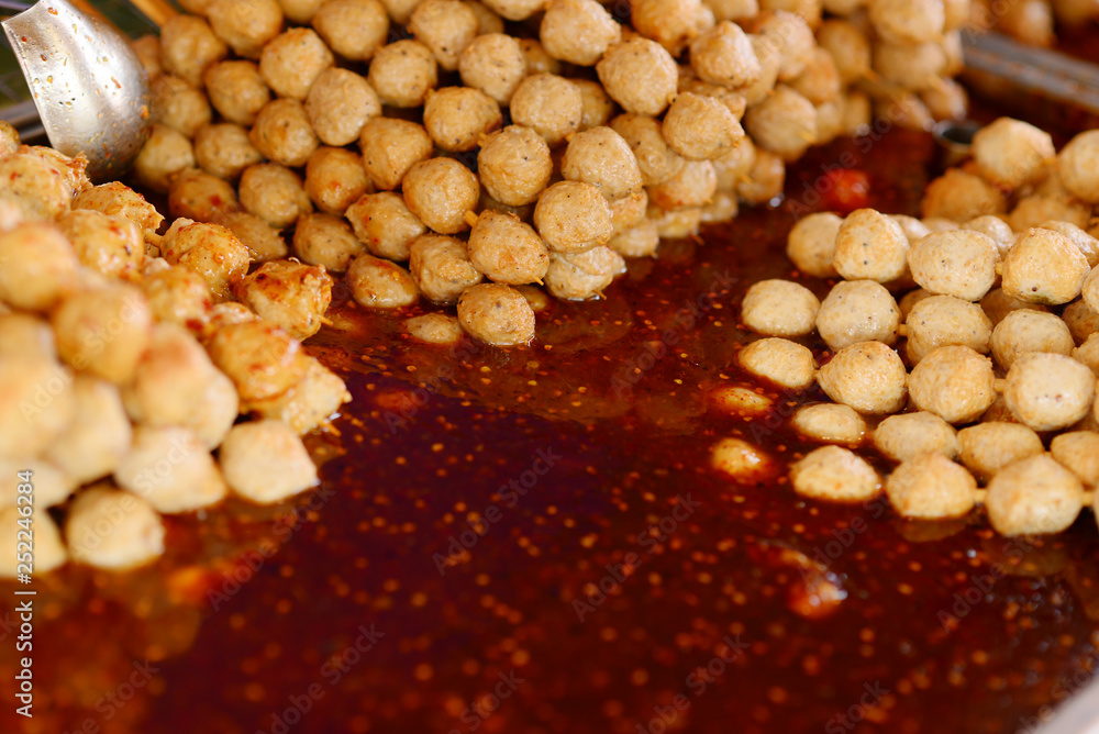 Fried meatballs in dipping sauce or chili paste. Selective focus. Fried meatballs in dipping sauce or chili paste. Selective focus.