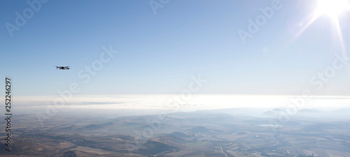 drone in the sky recording the scene with the sun