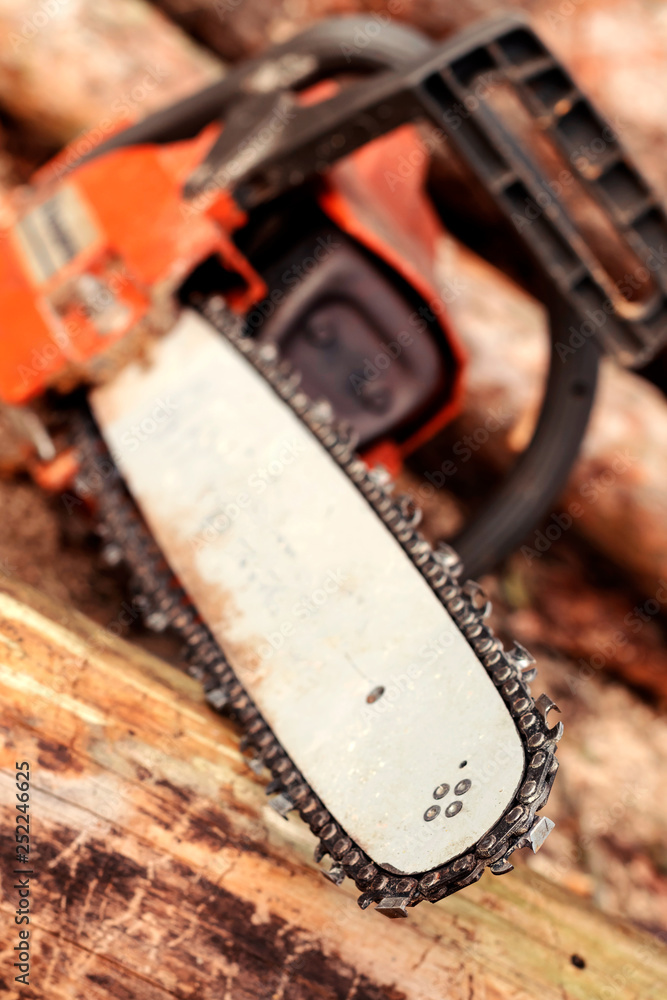 Professional chainsaw blade cutting log of wood. Heavy duty wood cutting equipment. Professional chainsaw blade cutting log of wood. Heavy duty wood cutting equipment.