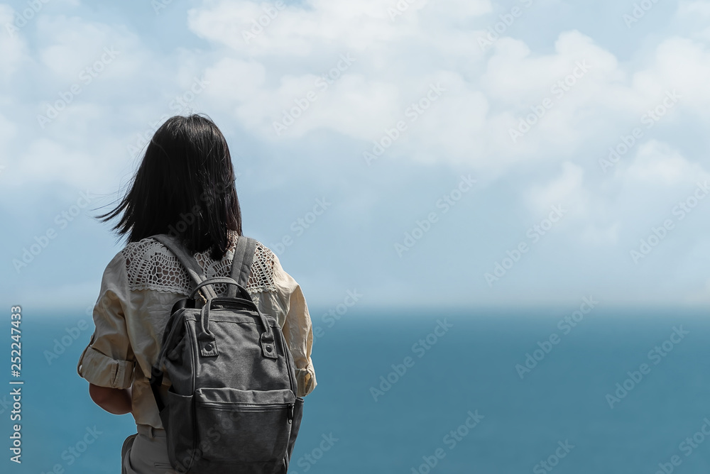 Solo Asian beautiful girl backpack traveller standing alone and looking the sea ,enjoy her vacation feel freedom and fresh air,Freedom lifestyle concept Solo Asian beautiful girl backpack traveller standing alone and looking the sea ,enjoy her vacation feel freedom and fresh air,Freedom lifestyle concept