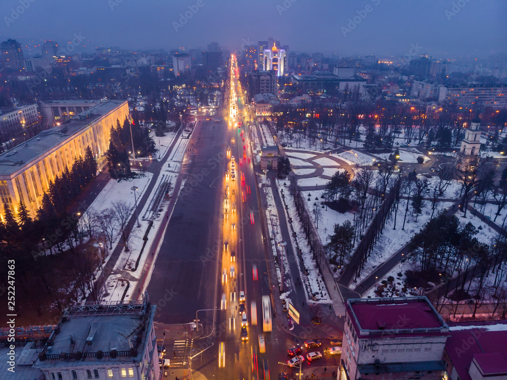 Fototapeta premium City center Chisinau at night with light and blue sky, government building and arch, Moldova. Aerial drone view