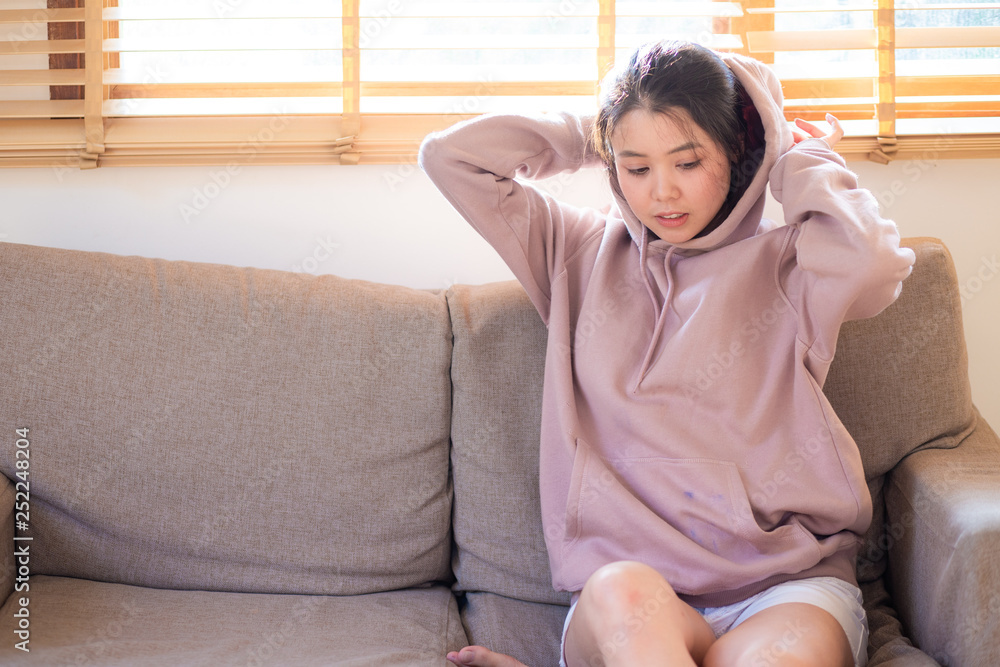 Beautiful asian young women sitting on sofa with sun light on window Beautiful asian young women sitting on sofa with sun light on window