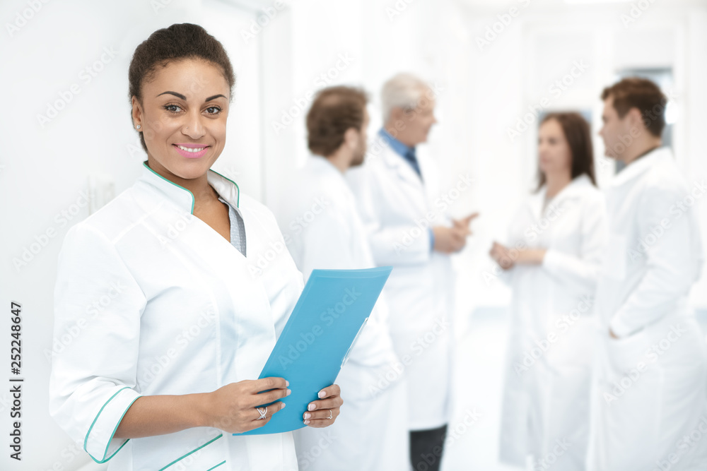 Diverse team of medical professionals standing at the hospital corridor Diverse team of medical professionals standing at the hospital corridor