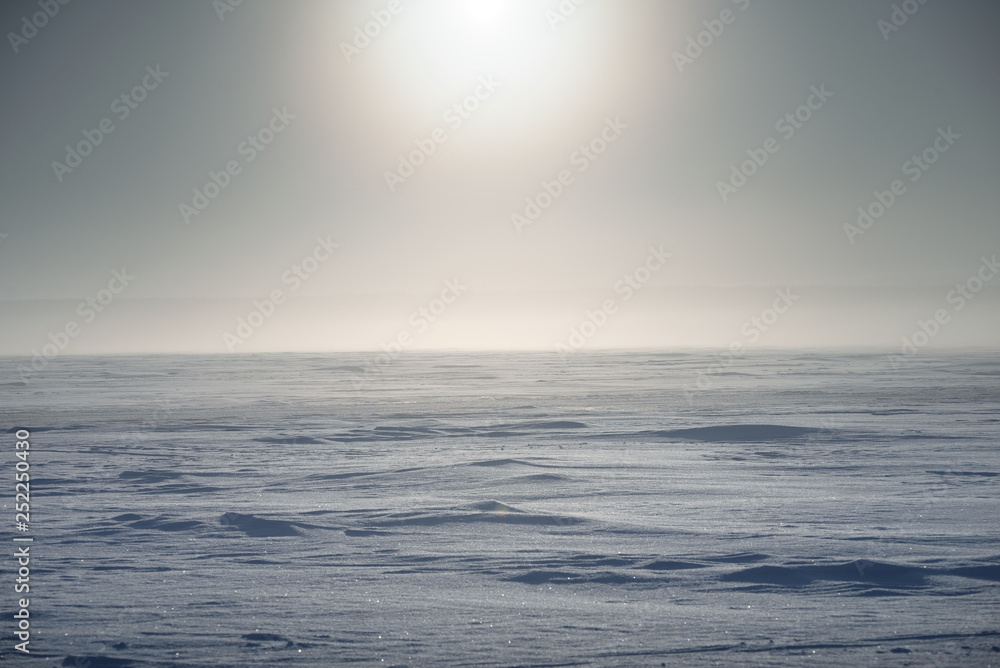 Obraz premium Winter landscape. The surface of the frozen sea. A little fog