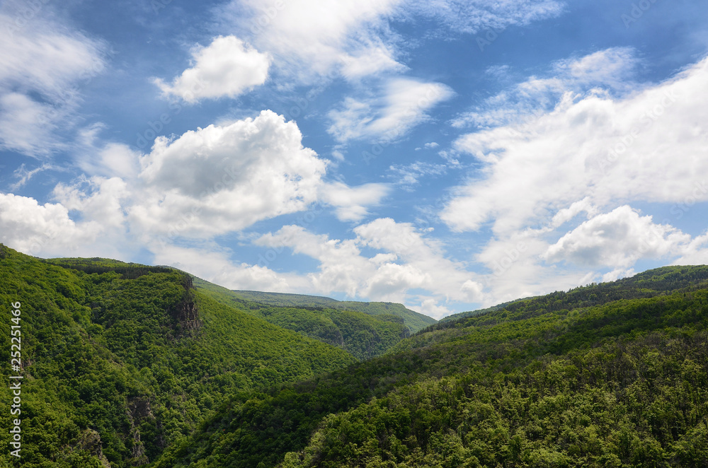 Spring mountain landscape with white puffy clouds Spring mountain landscape with white puffy clouds