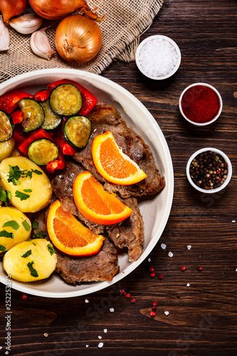 Grilled steak, boiled potatoes and vegetables