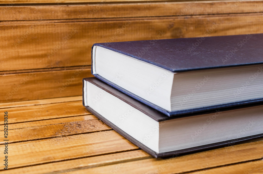 books on a brown, wooden background books on a brown, wooden background