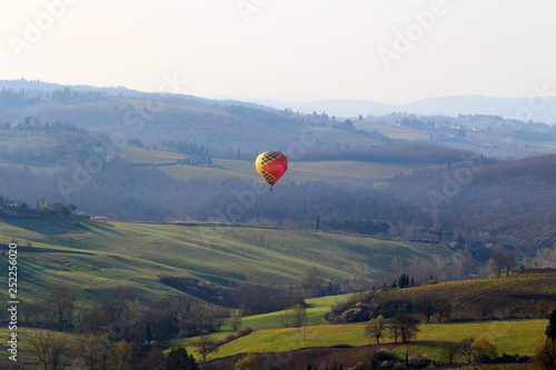 A hot air balloon at sunrise above the Chianti hills south of Florence in Tuscany