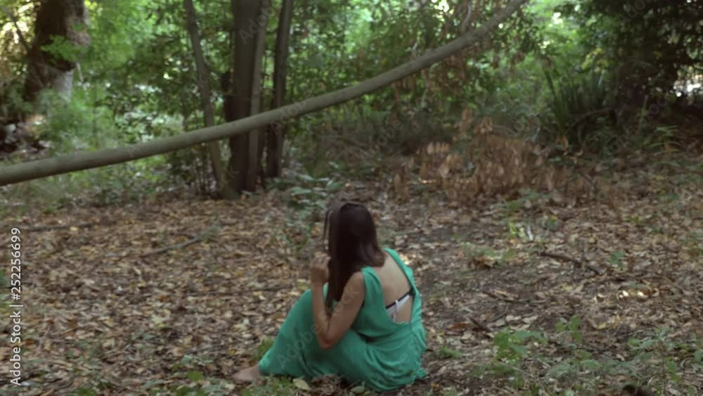 scared shocked lonely woman sit in the forest. Assault,violence,crime scared shocked lonely woman sit in the forest. Assault,violence,crime