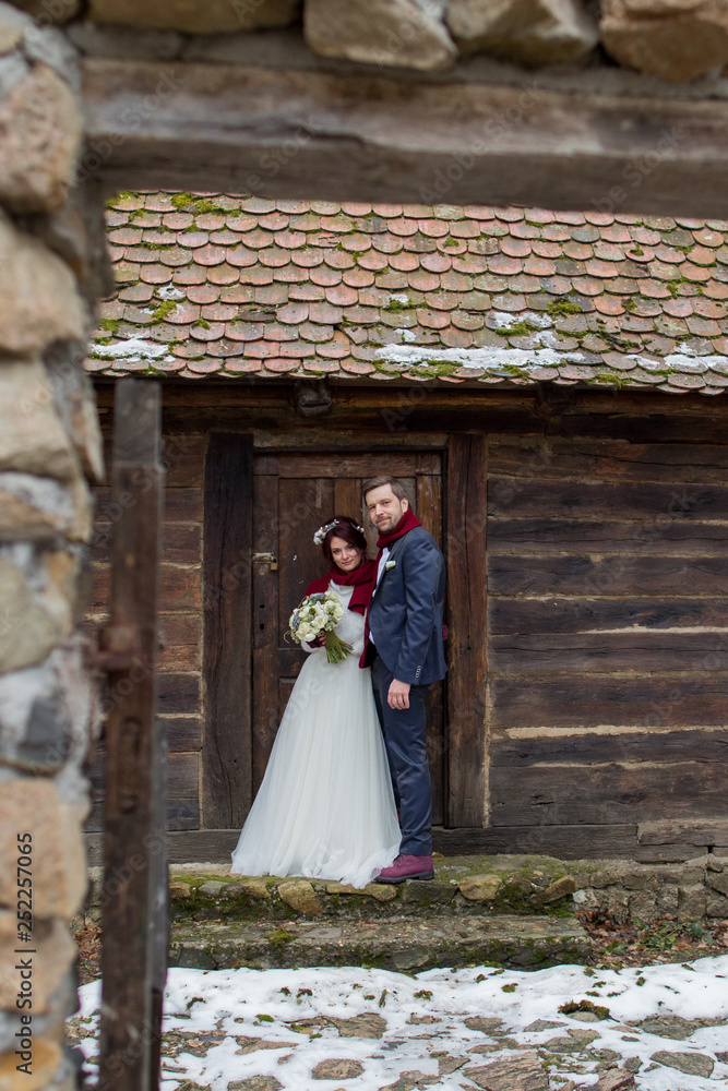 Fototapeta premium Beautiful wedding couple posing in old village