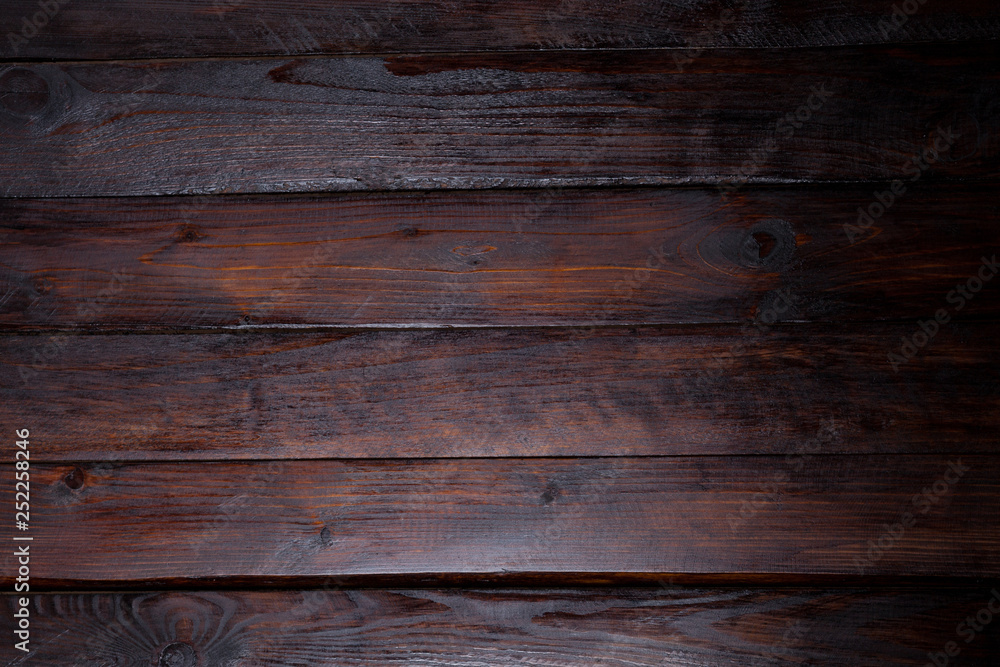 Dark wooden background. Abstract texture. Top view of the wooden boards Dark wooden background. Abstract texture. Top view of the wooden boards