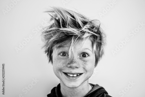 Portrait of a young boy with freckles and wild hair photo