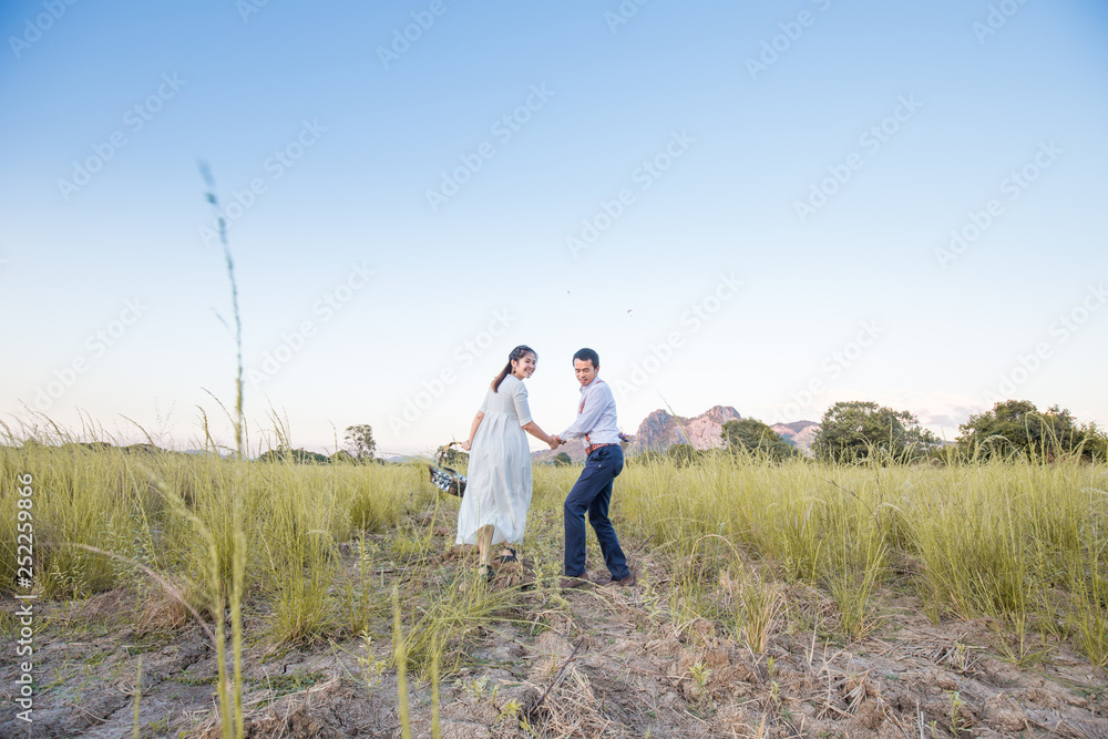 Couple of love running together in green field Couple of love running together in green field