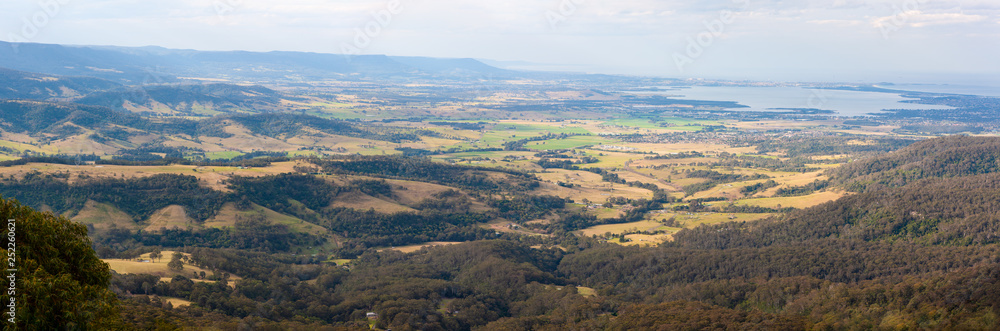 Panorama of Lake Illawarra and surrounding countryside with fields and farms, New South Wales, Australia