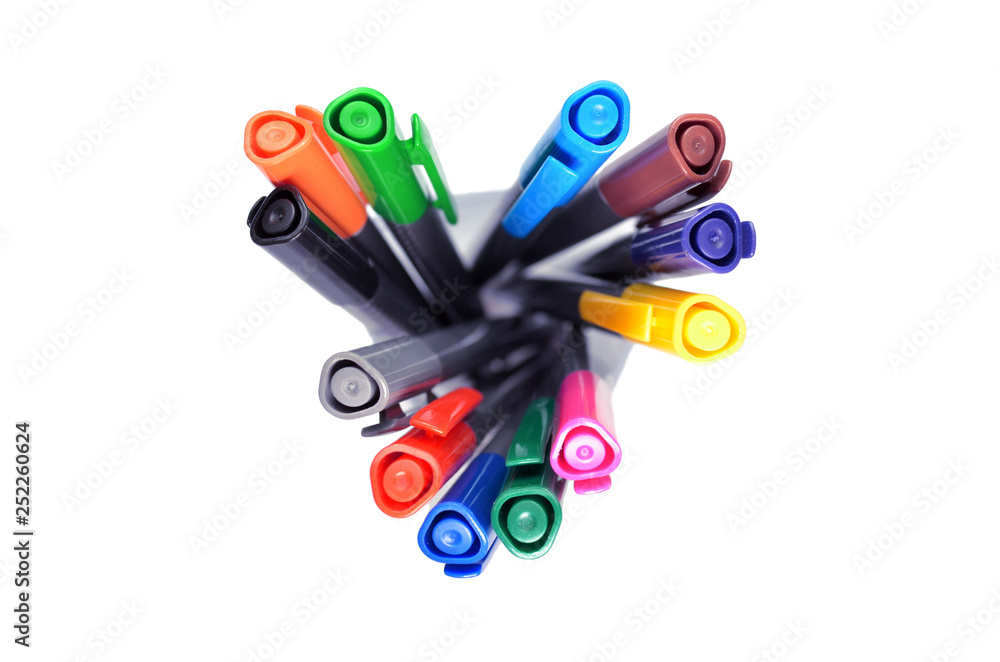 Set of multi-colored pens standing in a transparent glass, top view on  white background, isolated, horysontally oriented Stock Photo