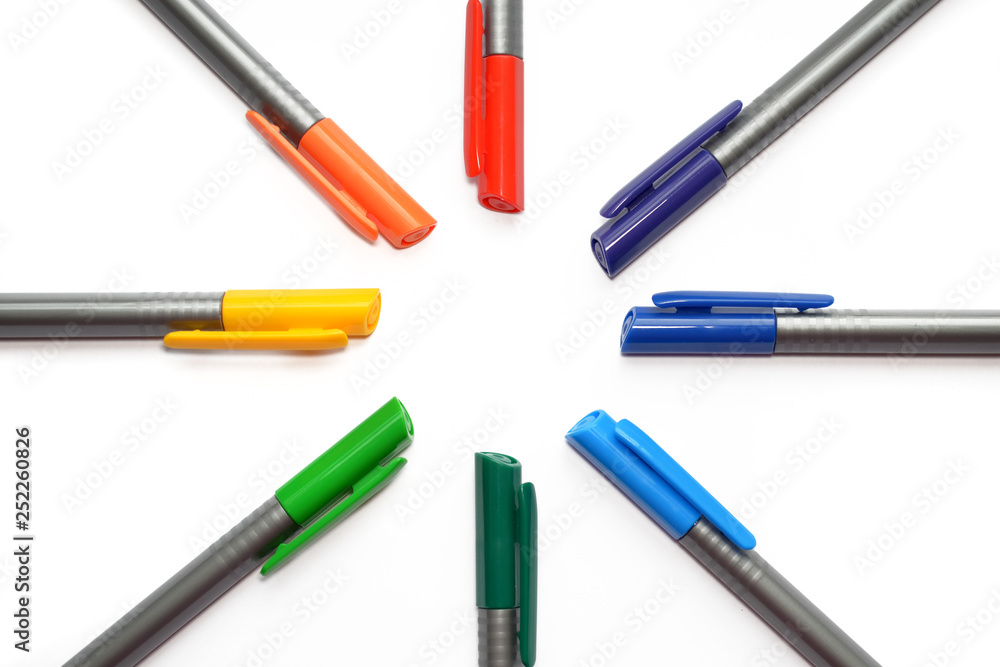 Set of rainbow pens, lying in shape of sun and rays isolated on white background with copyspace